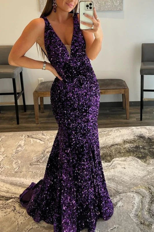 Woman posing in a sparkling mermaid V-neck sequin long prom dress.