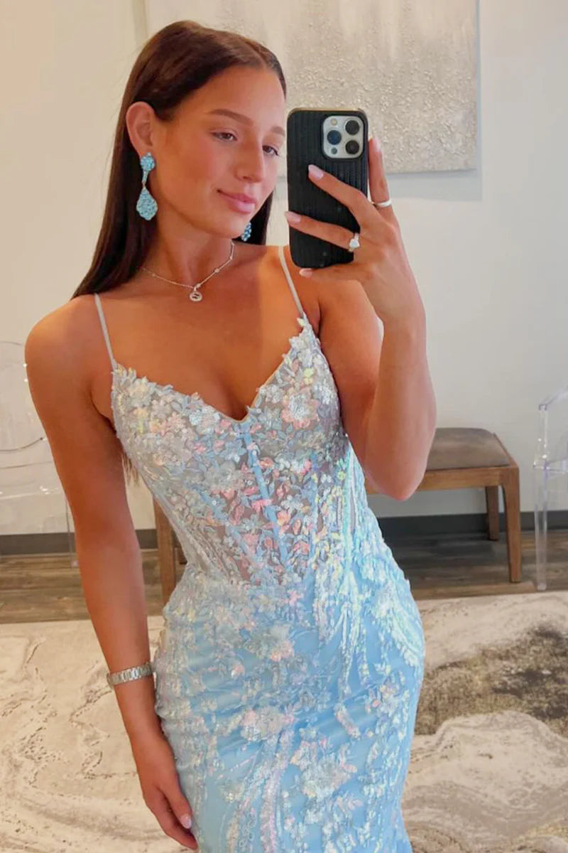 Side view of a woman wearing a long sequin mermaid dress.