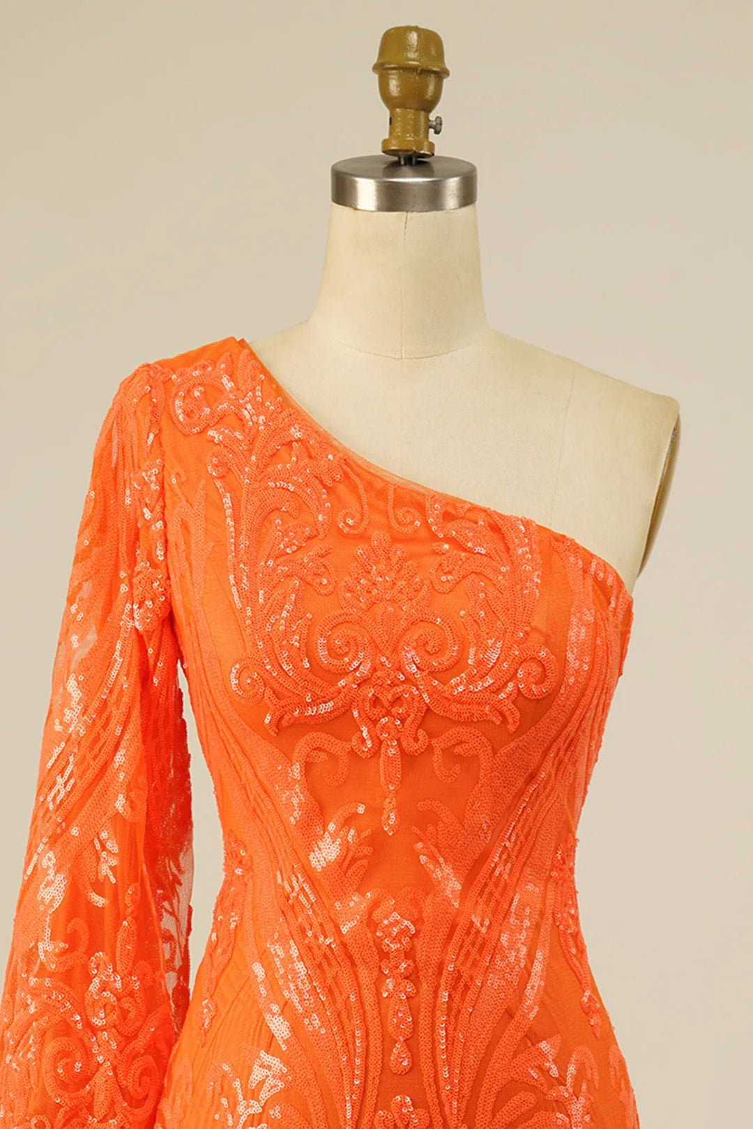 Close-up of sequin and embroidery on the long sleeve dress.