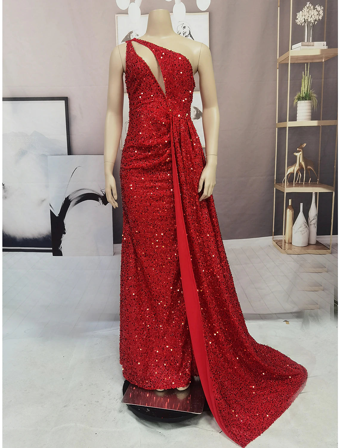 Side view of a glamorous one-shoulder mermaid dress with a high leg slit.