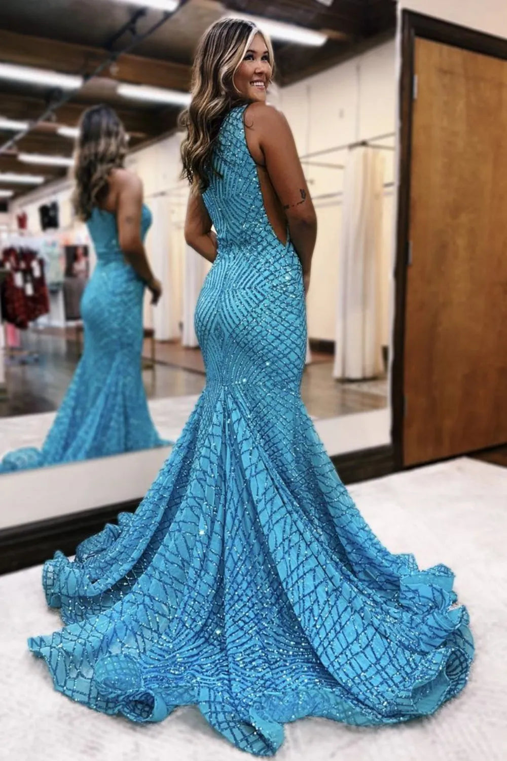Back view of a woman in a sequin mermaid long formal gown.