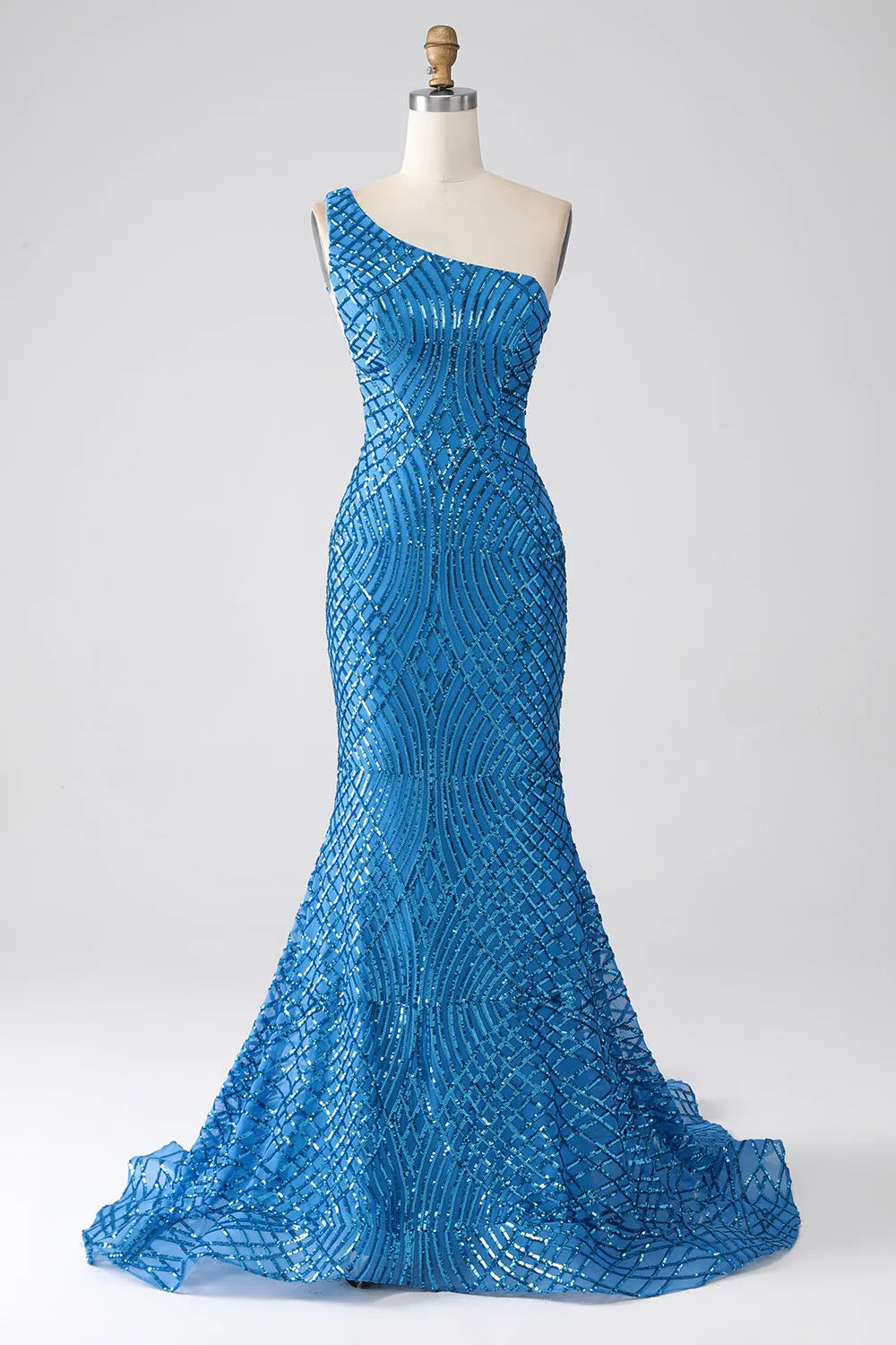 Woman posing in an elegant one-shoulder sequined mermaid dress.