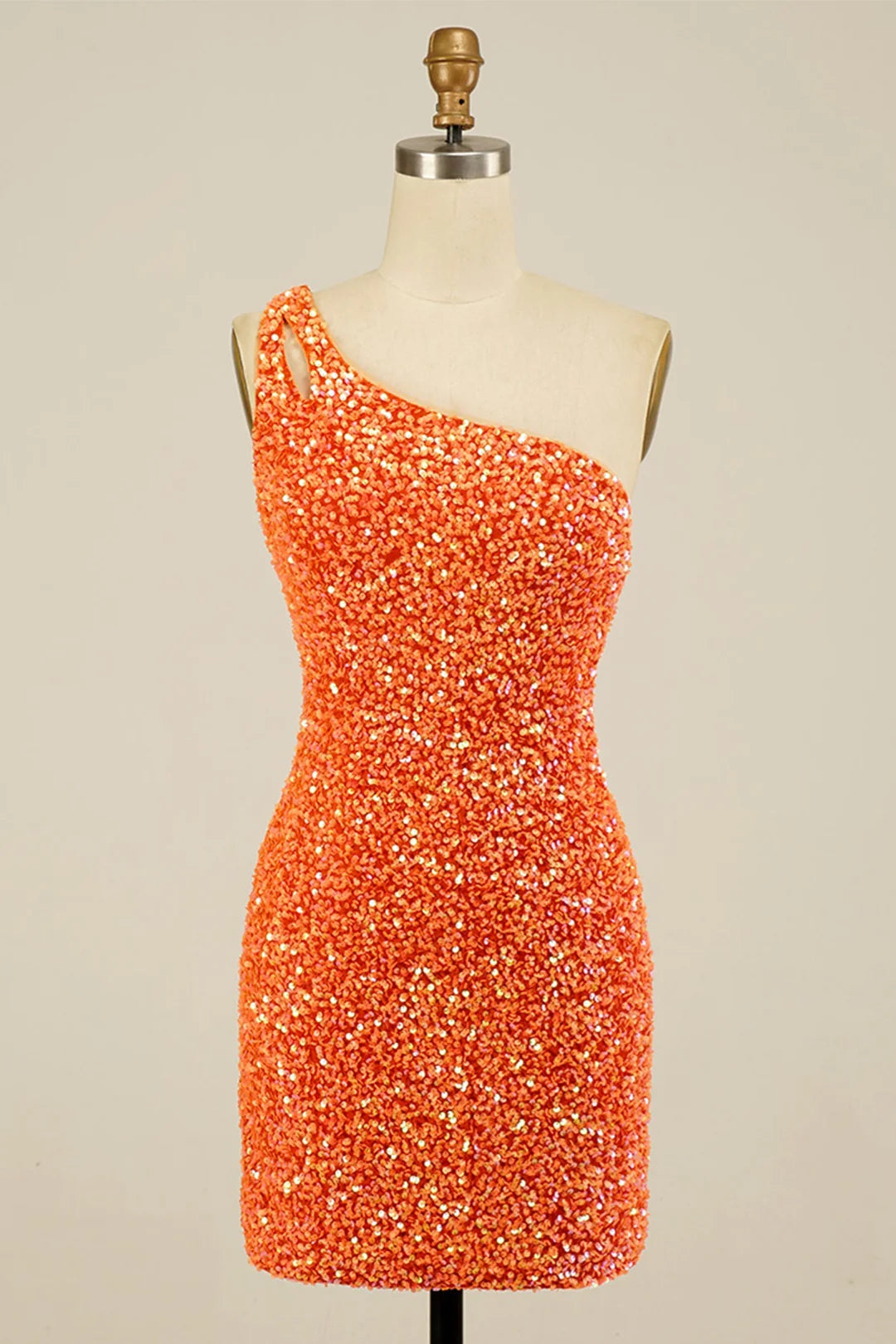 Model posing in a sparkling one-shoulder sheath mini dress.