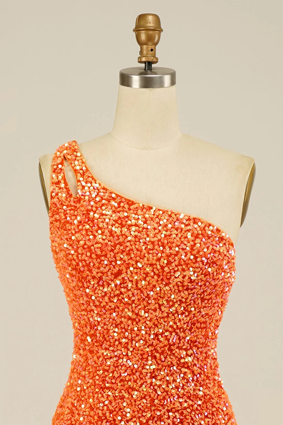 Close-up of the sequin fabric on the one-shoulder dress.
