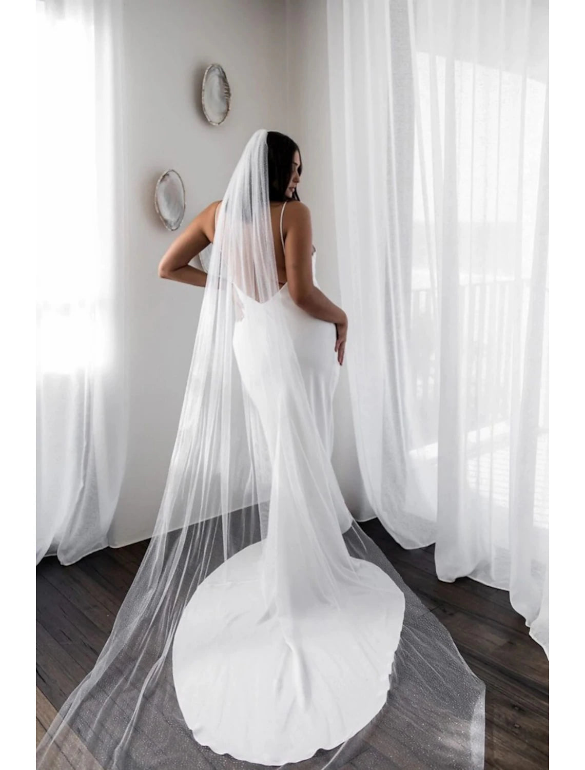 Full view of a long, flowing cathedral wedding veil with sparkle.