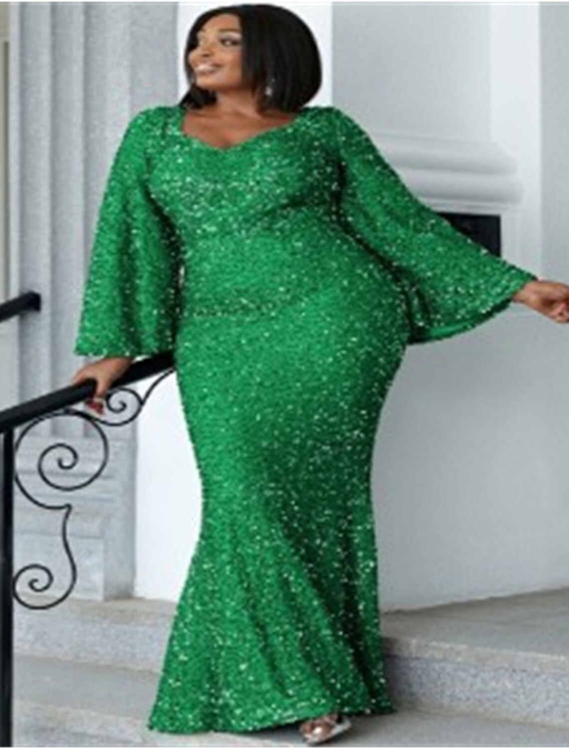 Close-up of the sequin and glitter detail on a plus size evening gown.