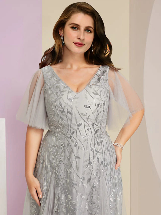 Side view of sparkling plus size floor-length dress with tulle and pleats.