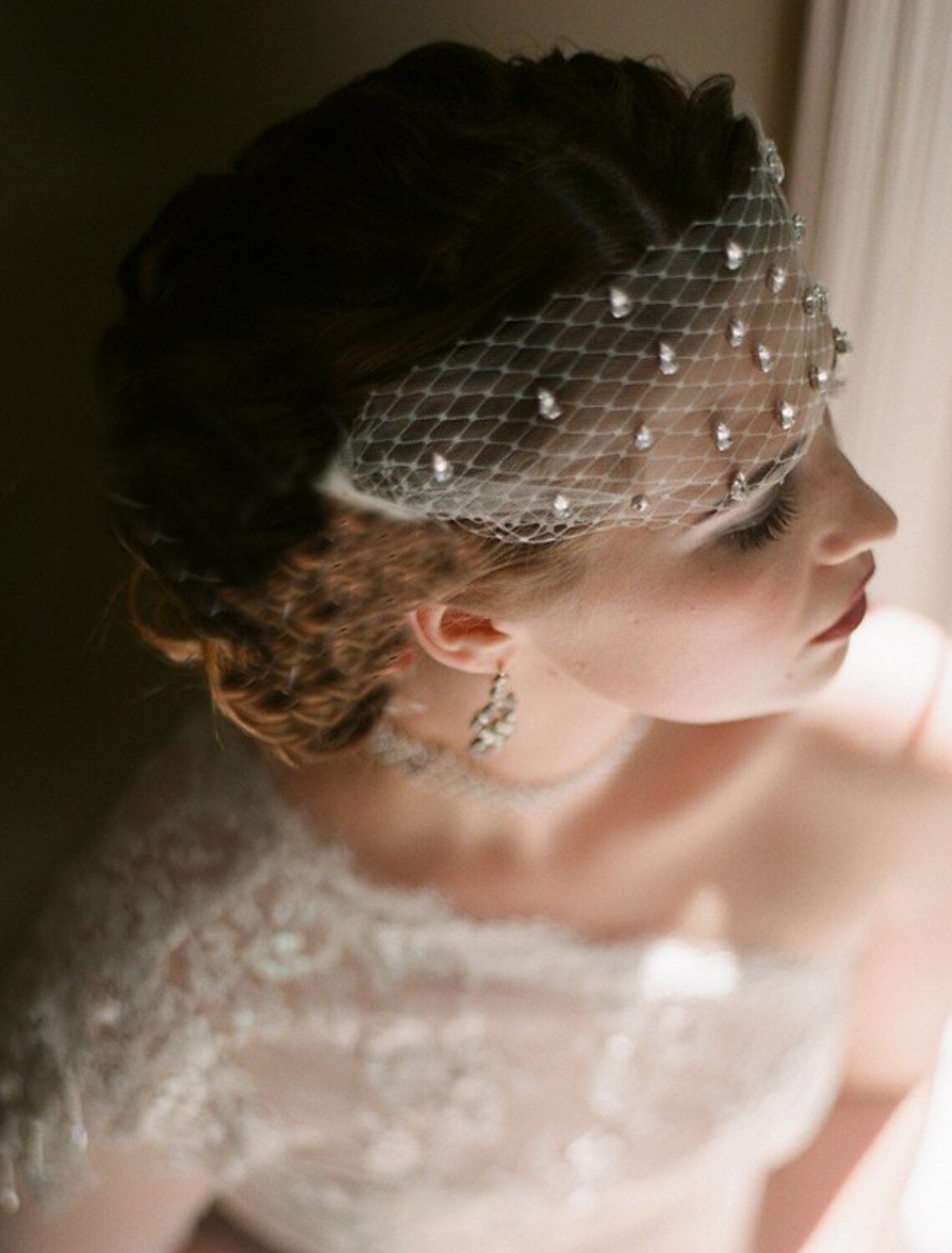 Bride wearing a sparkling one-tier rhinestone wedding blusher veil.