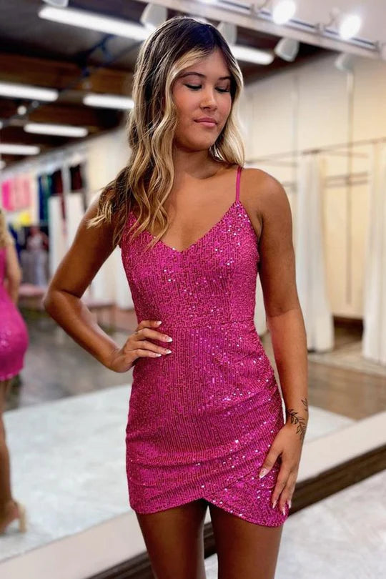 Woman wearing a sparkling sequin bodycon mini homecoming dress with straps and a V-neck.
