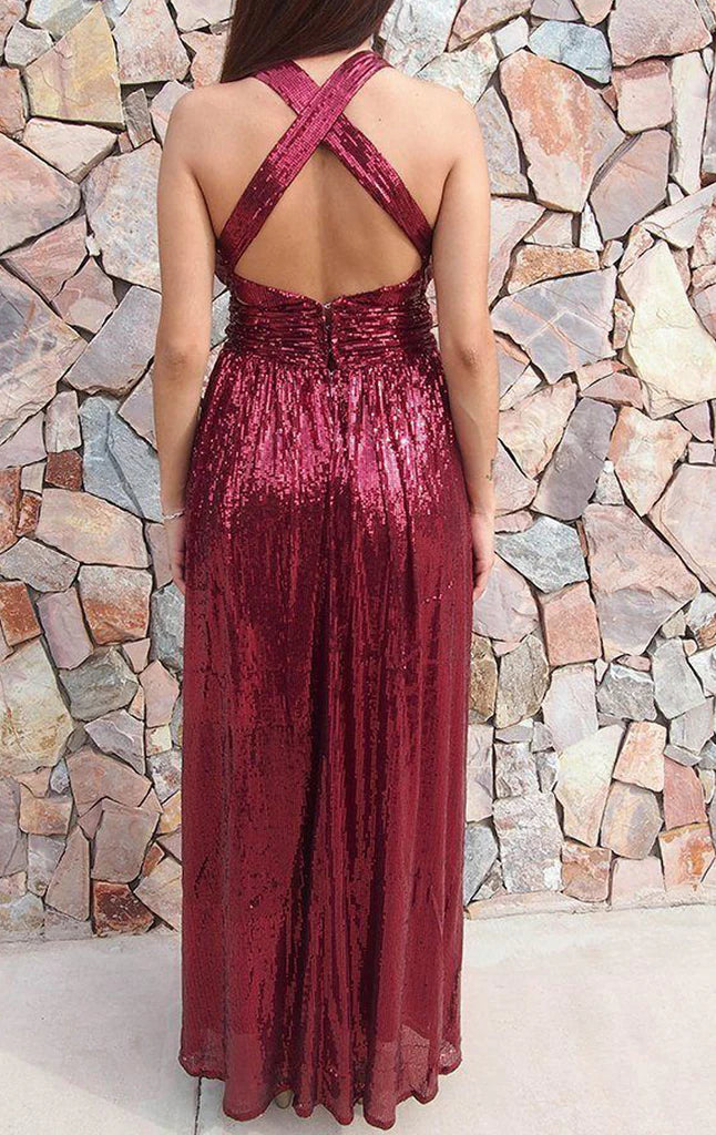 Woman posing in a sequin deep V-neck maxi formal gown.