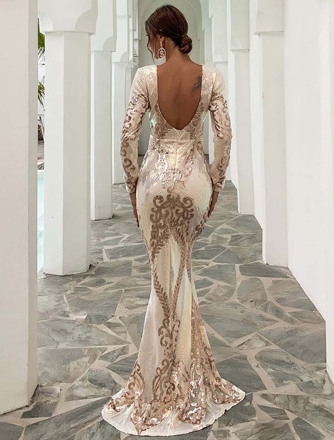 Full length view of a woman posing in a sequin mermaid formal dress.