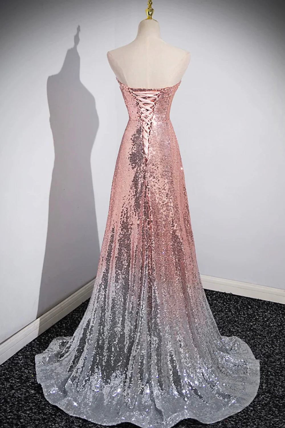 Back view of a woman in a long sequin mermaid formal gown.