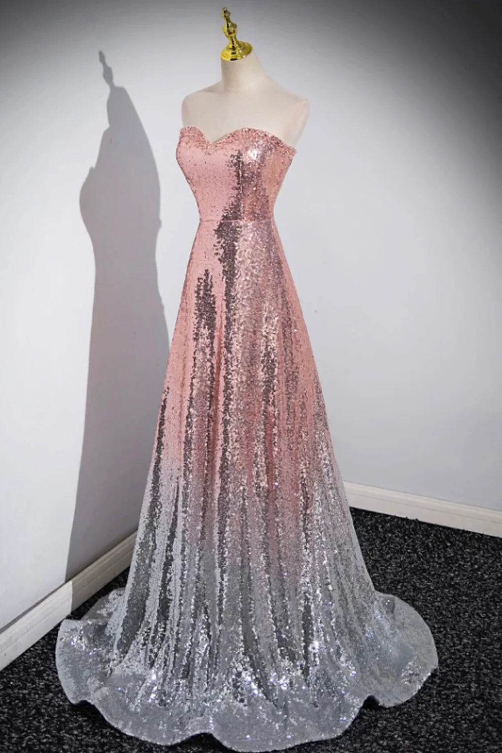 Side profile of a woman showcasing the mermaid silhouette of the sequin dress.