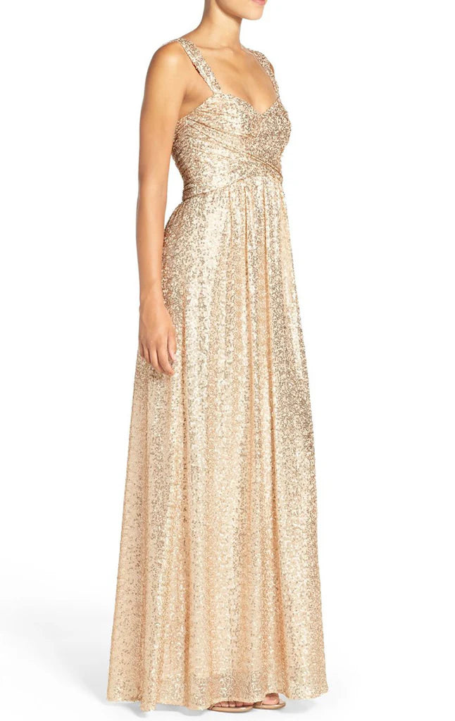 Side view of a long sequin prom gown.