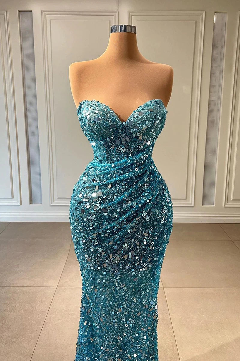 Back view of a shimmering sequined mermaid prom dress, showcasing its floor-length silhouette.