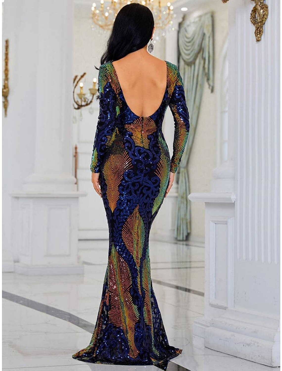 Close-up of the sequined and glitter fabric on the long sleeve gown.