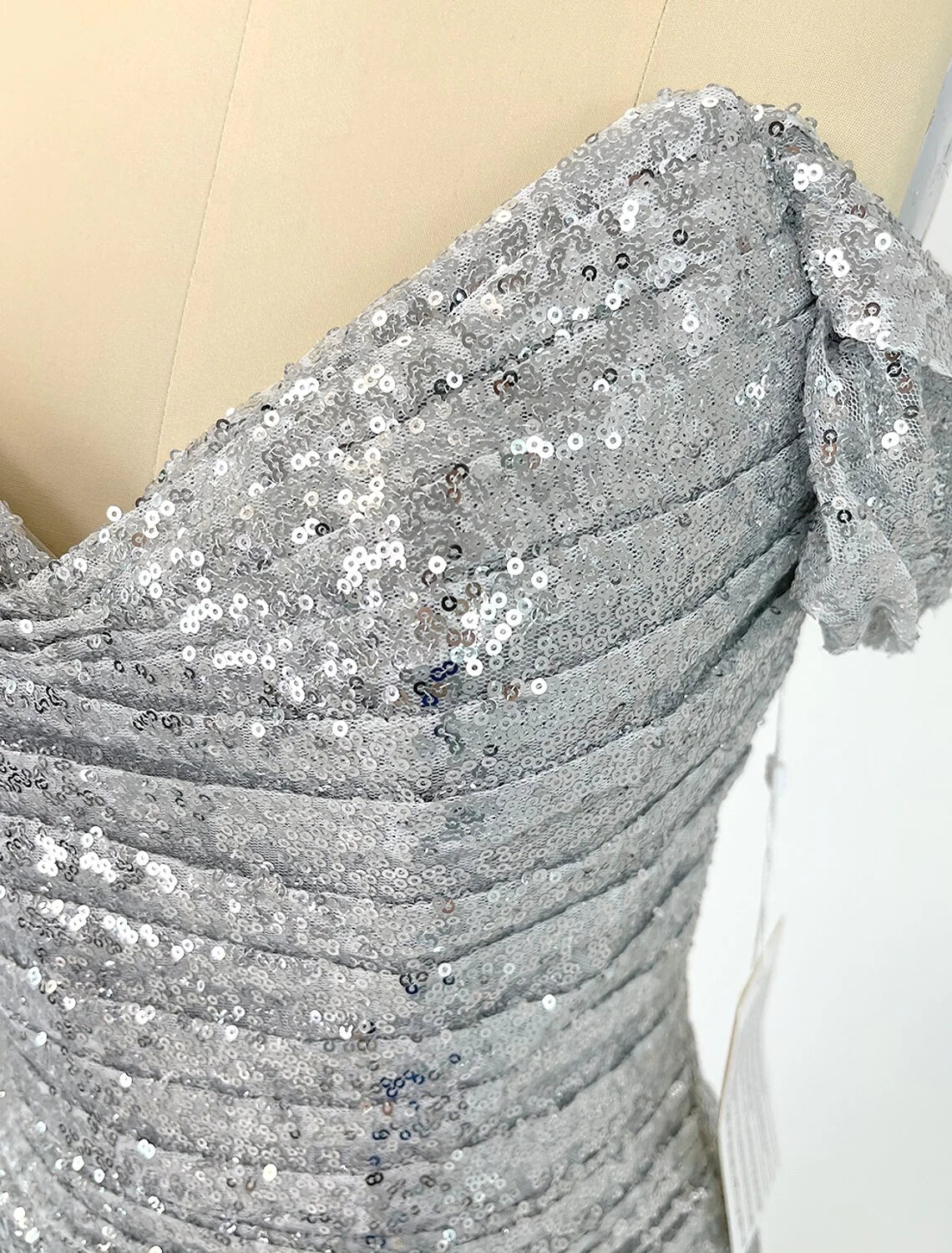 Full length view of a woman in the sparkling sequined mermaid evening gown.