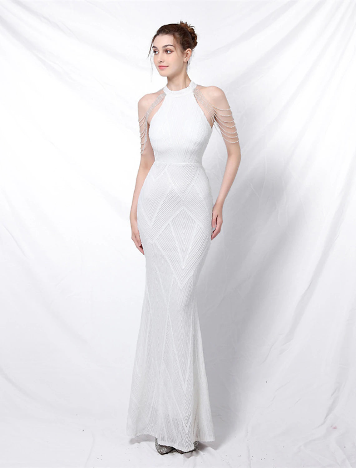 Back view of the high neck evening gown, highlighting its backless design.