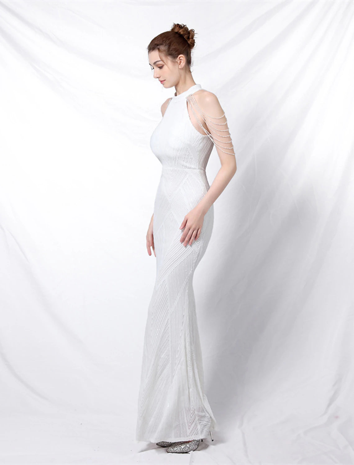 Full length view of the mermaid trumpet gown, emphasizing its elegant drape.