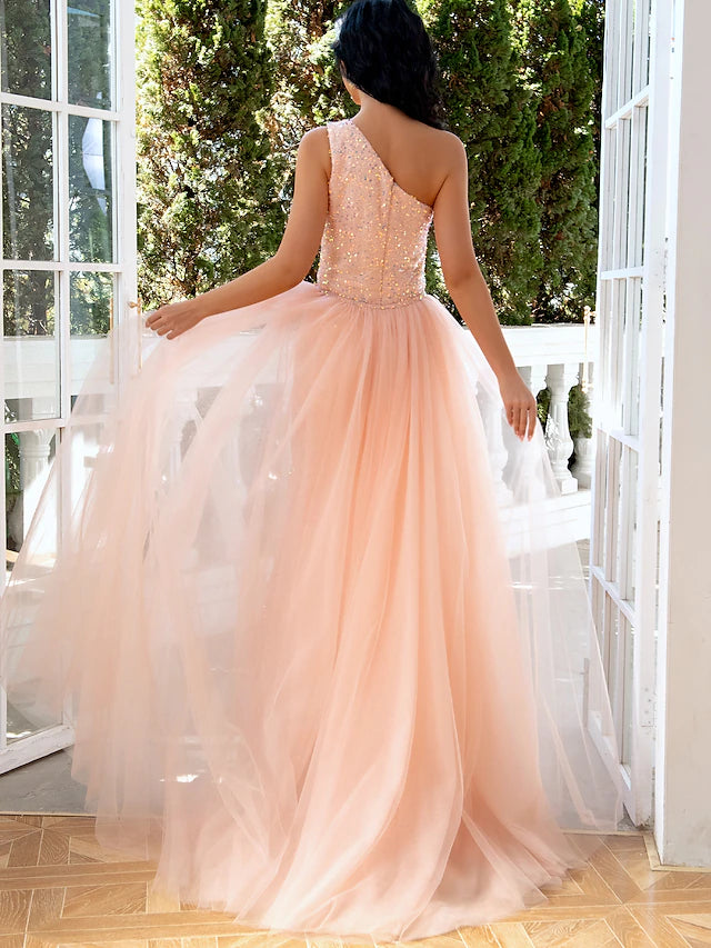Side profile of a woman wearing the sparkling one-shoulder evening dress.