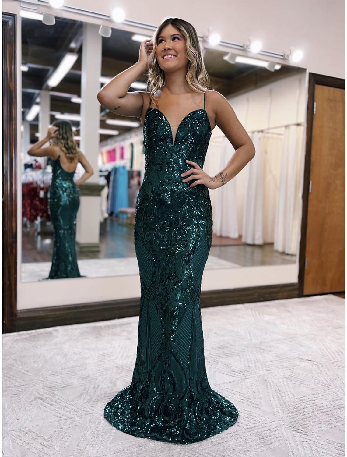 Back view of a sparkling sequined mermaid prom dress showing the backless design.