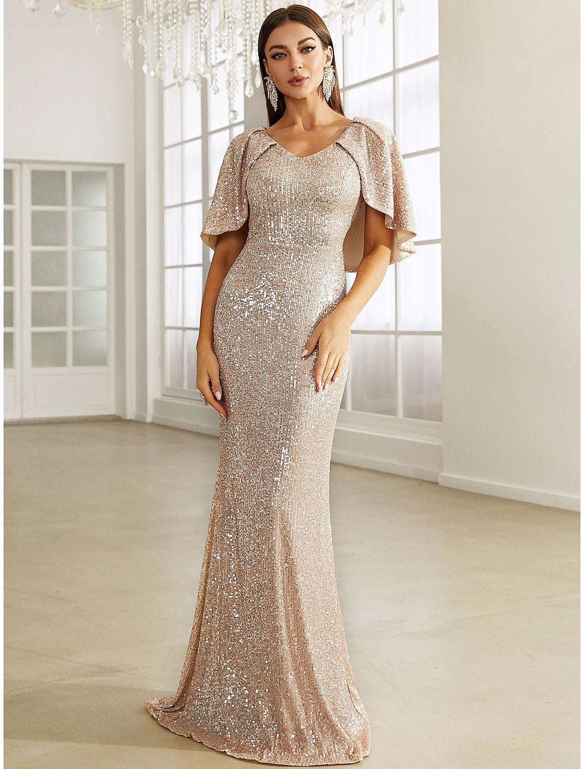 Sparkling sequined mermaid trumpet evening gown with V-neck and half sleeves.