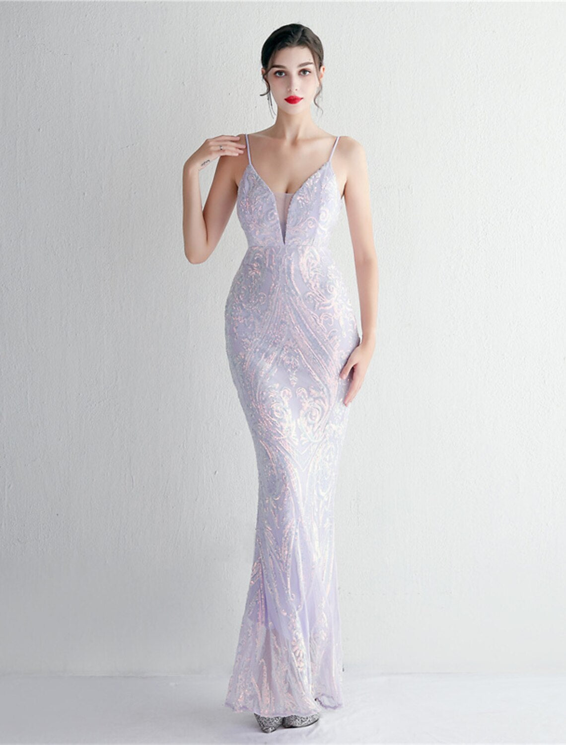 Sparkling sequined mermaid trumpet evening gown with spaghetti straps.