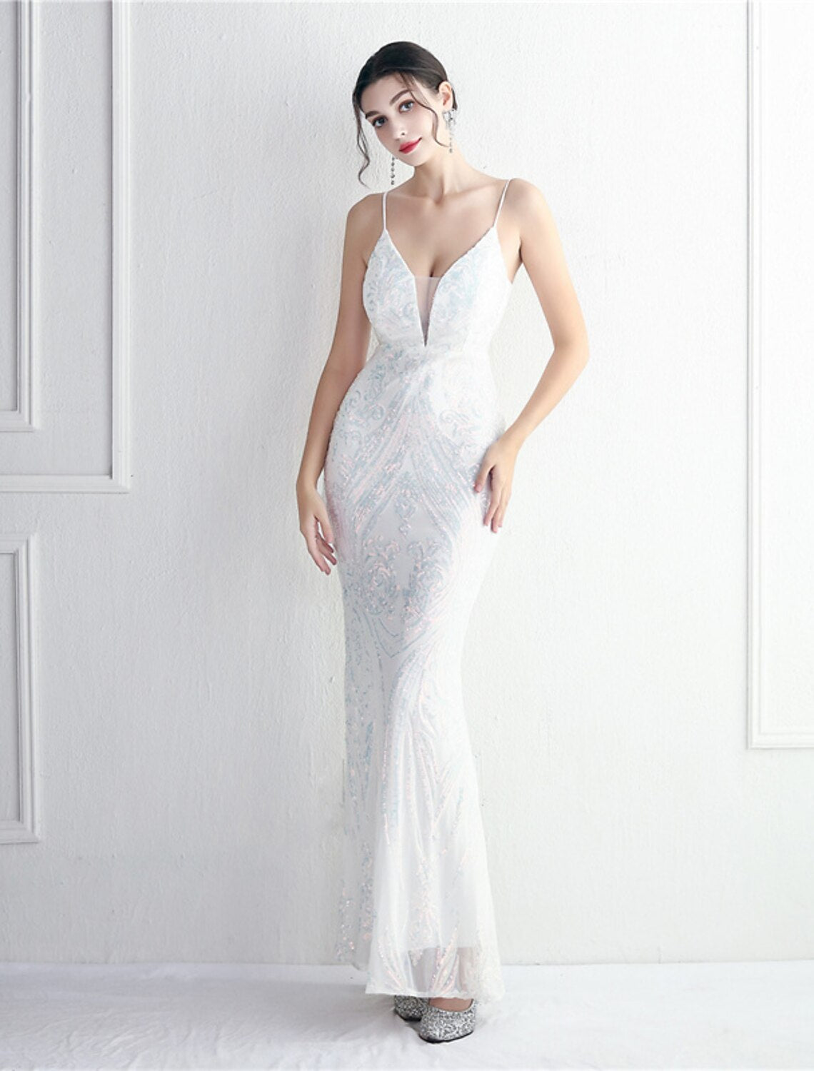 Back view of a sequined mermaid trumpet evening gown.