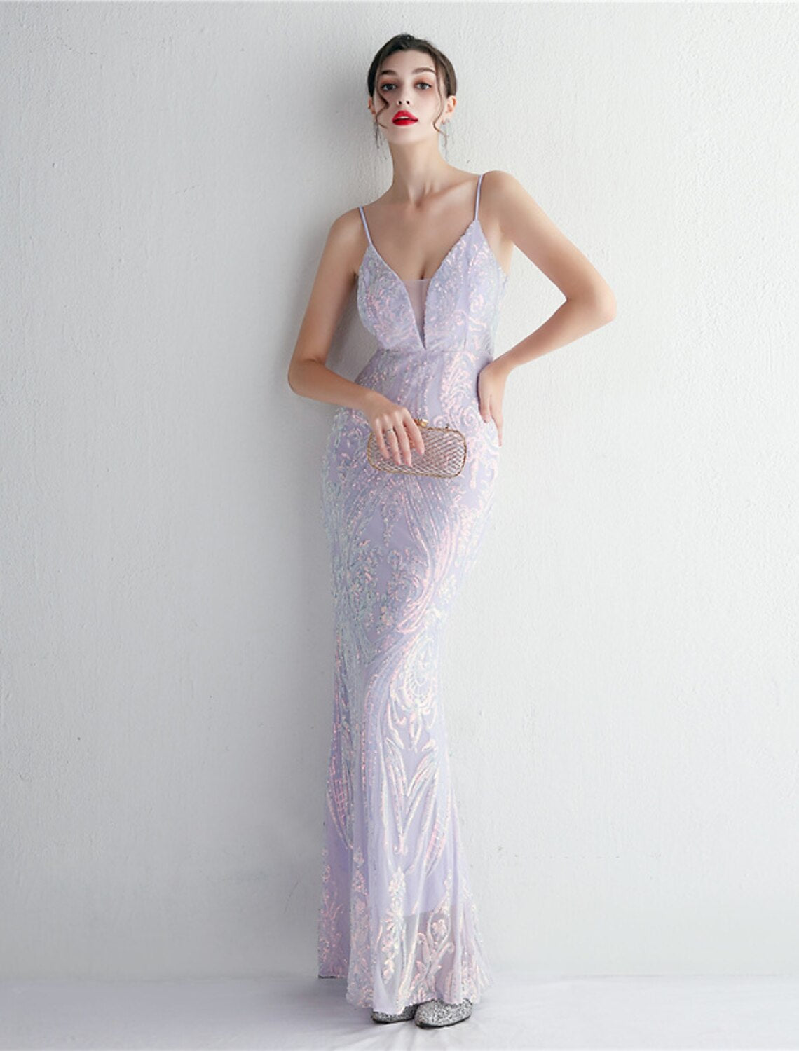 Woman posing in a sparkling formal evening gown.