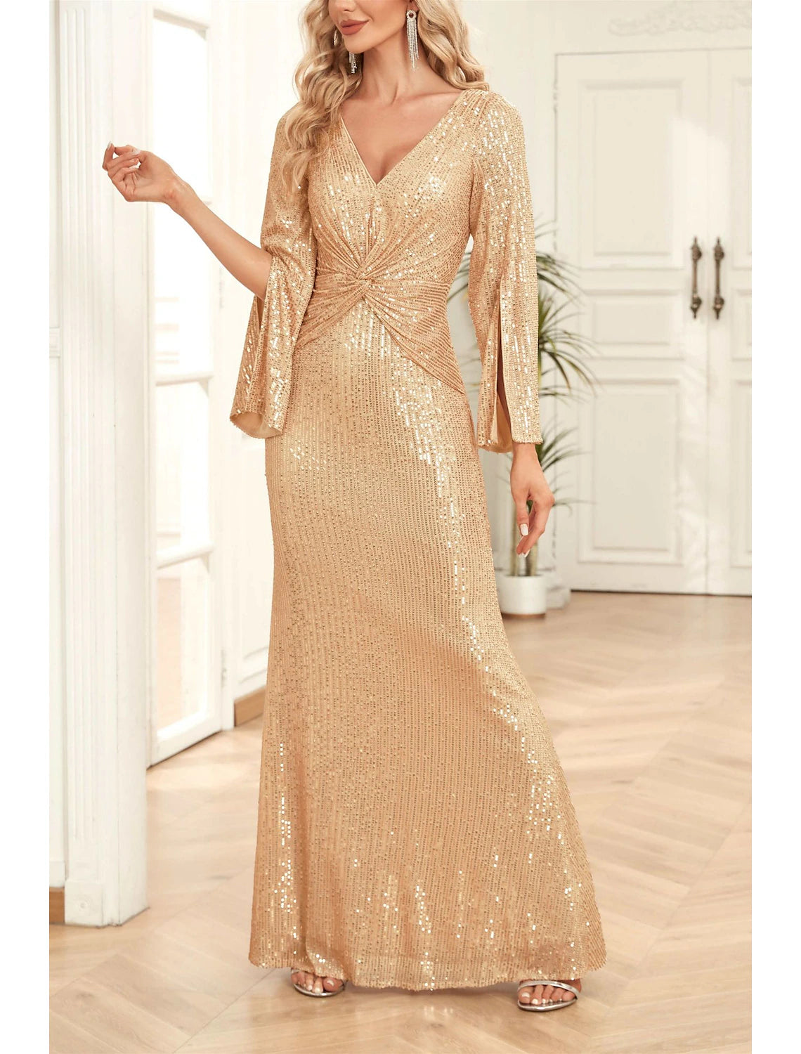 Woman posing elegantly in the sparkling V-neck 3/4 sleeve mermaid trumpet gown.