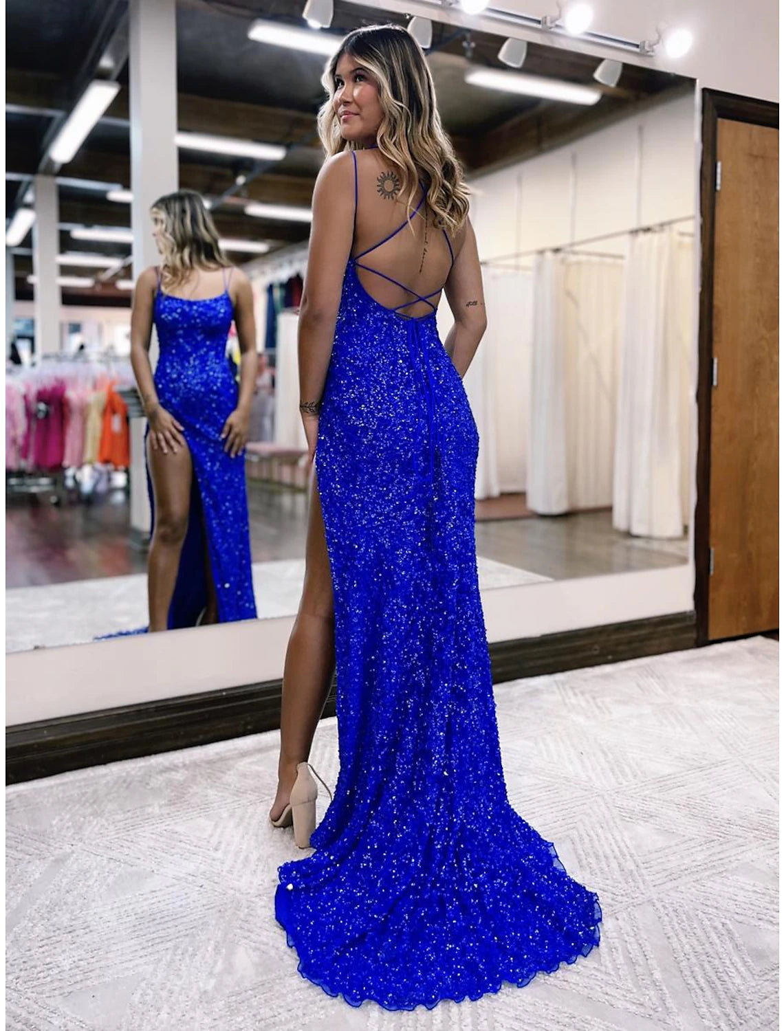 Back view of a sequined mermaid trumpet prom dress showing the sweep train.