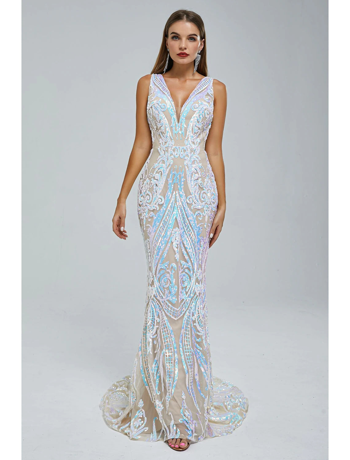 Woman wearing a sparkling sequined mermaid trumpet evening gown with a V-neck and court train.