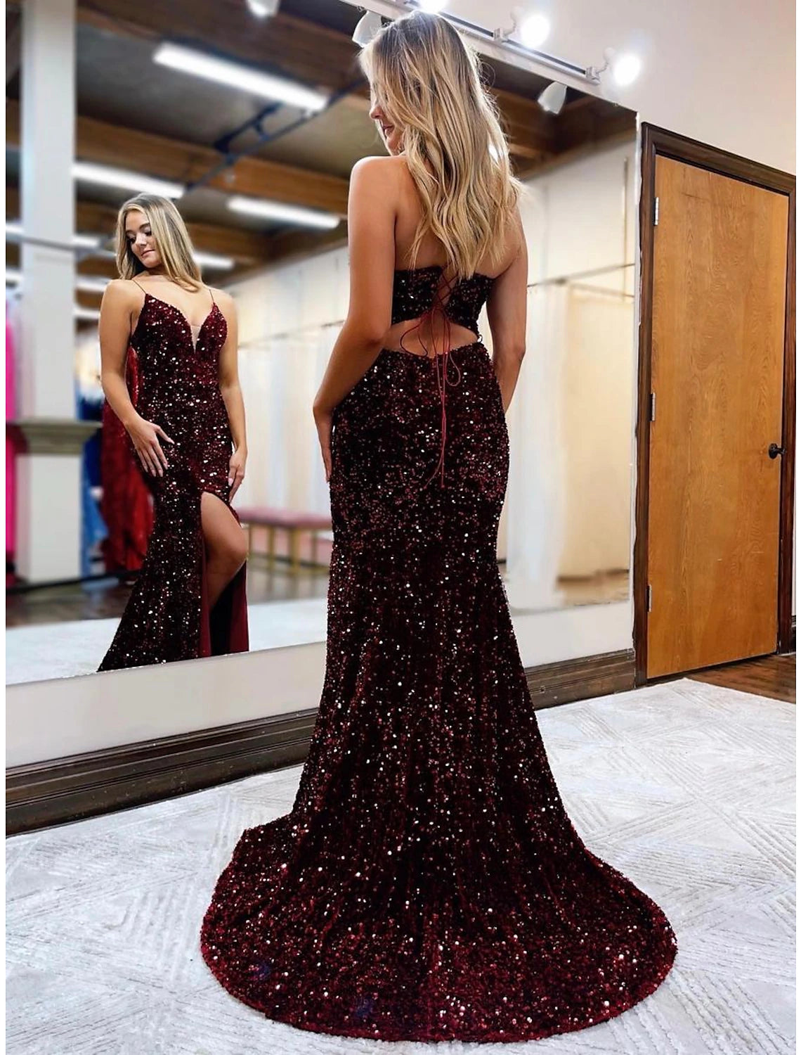 Back view of a sparkling sequined formal gown with court train.