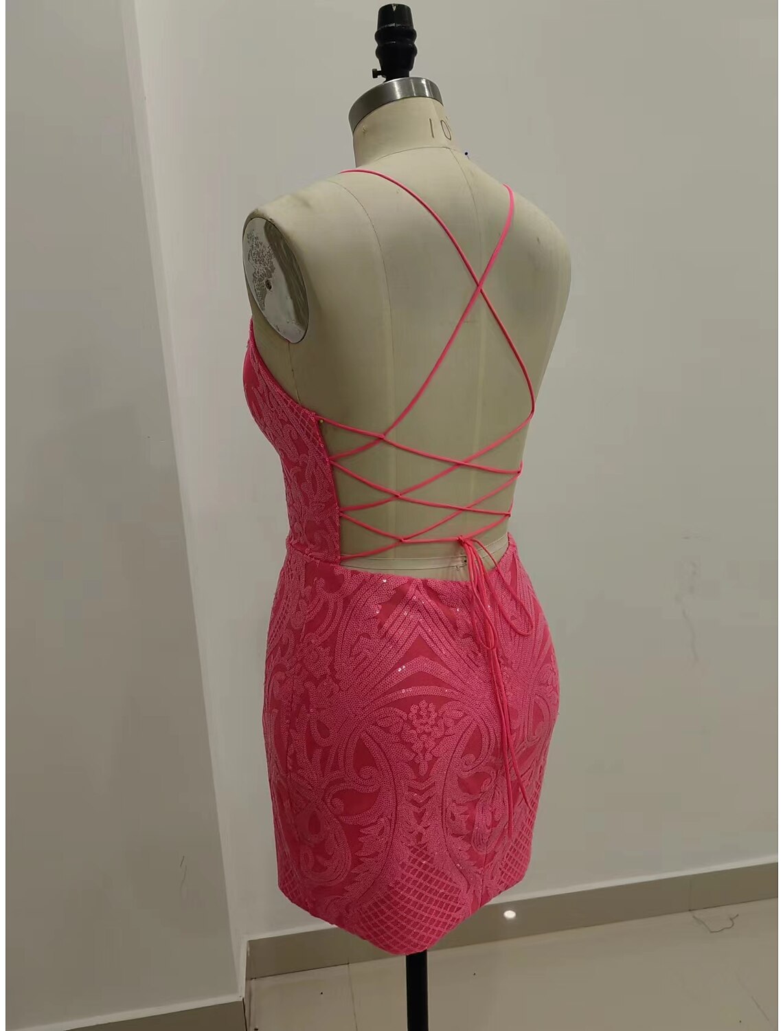 Back view of a sequined mermaid dress featuring a strappy, backless design.