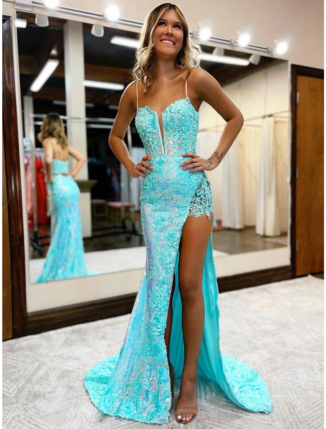 Sequined mermaid gown with high slit and V-neckline.
