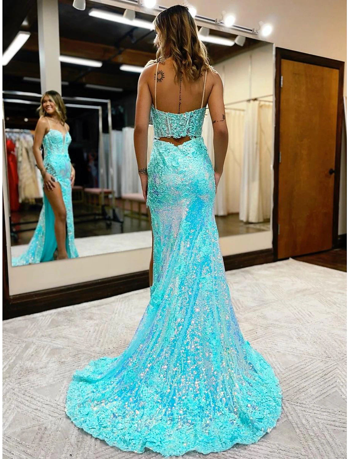 Side view of sequined mermaid dress with elegant court train.