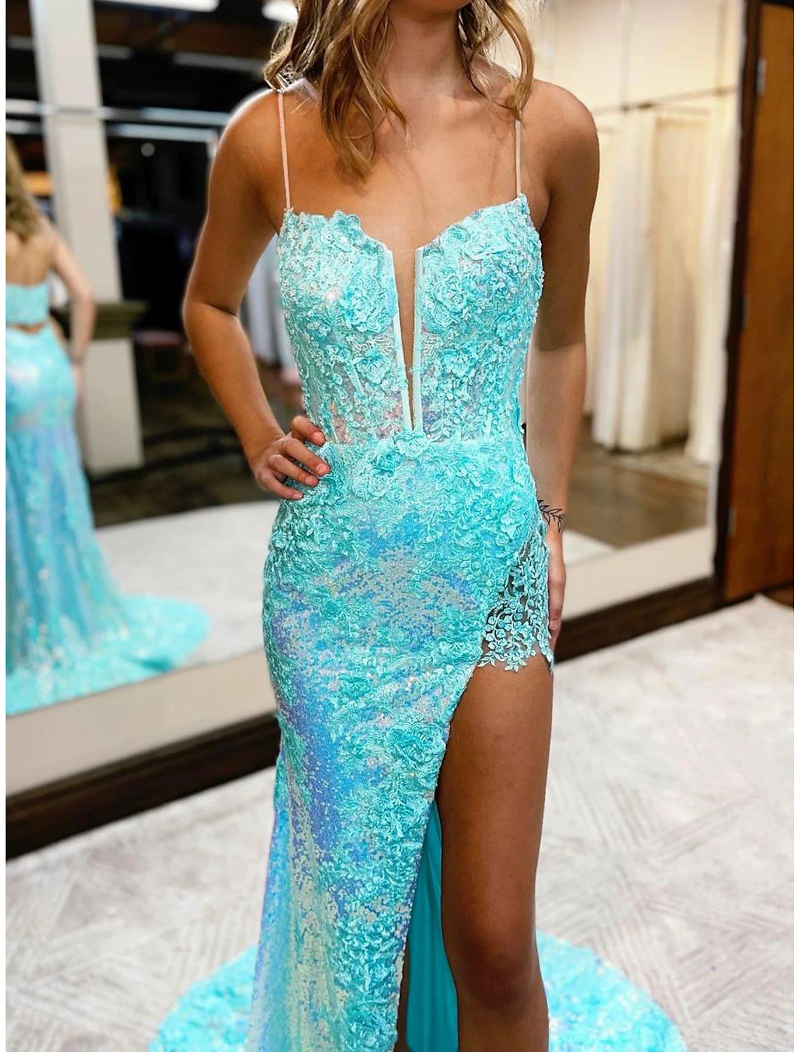 Back view of sequined mermaid dress with flowing court train.