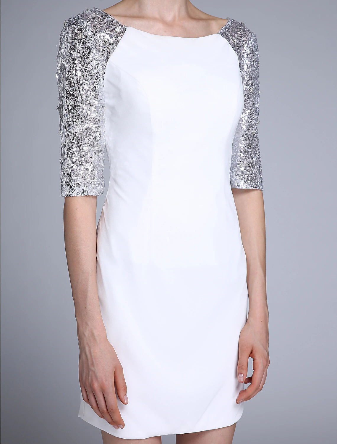 Woman wearing a sparkling sheath Mother of the Bride dress, back view.