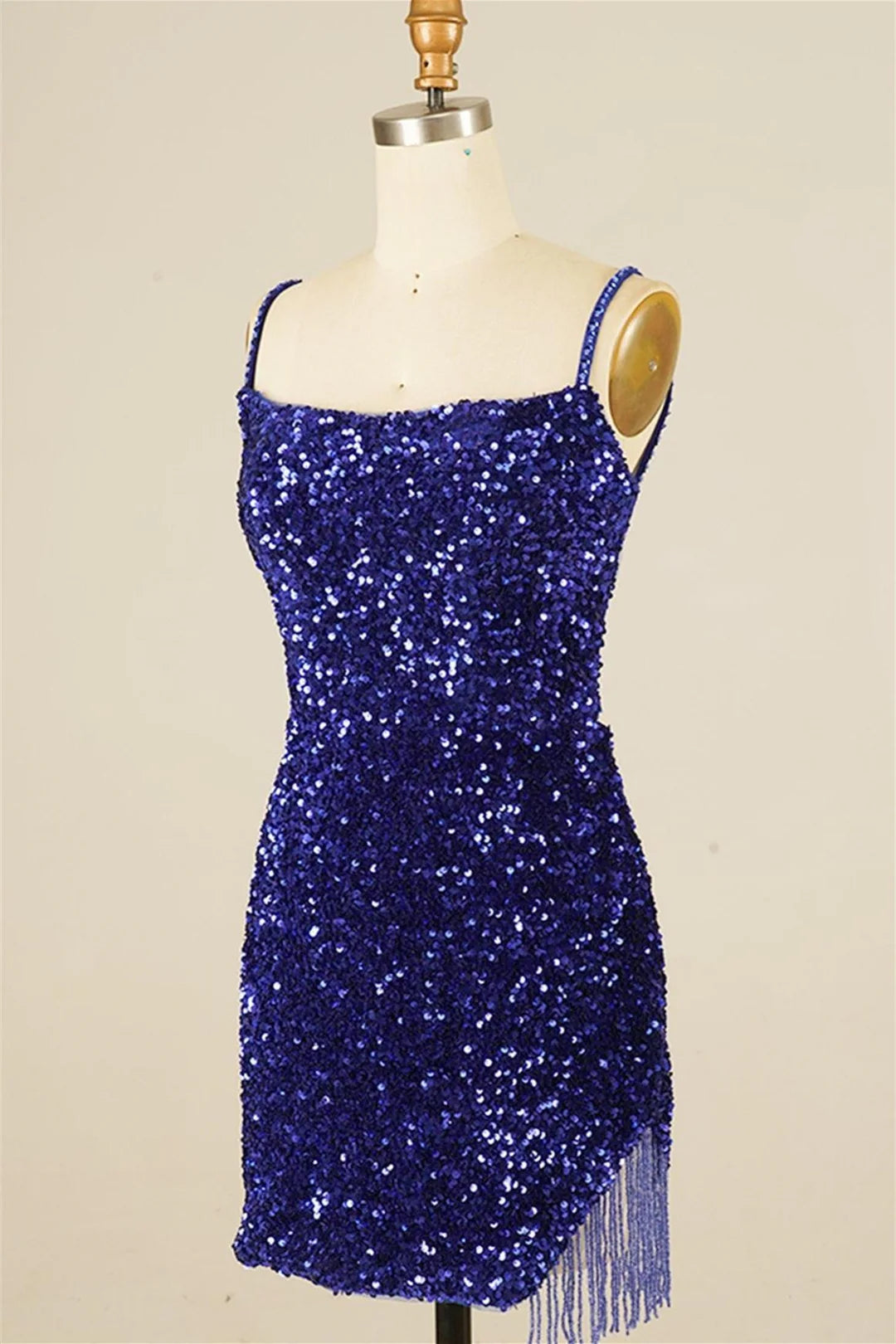 Close-up of the sequin embellishments and tassels on the dress.