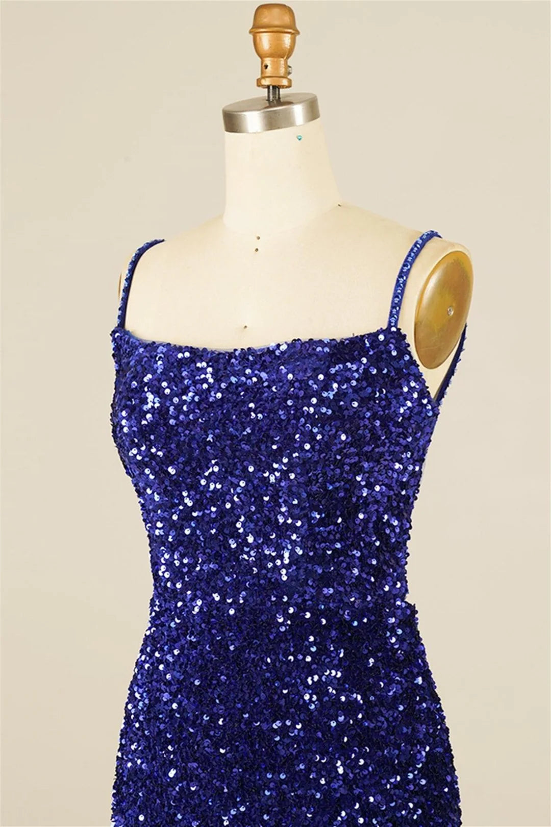 Side profile of the model wearing the sequined sheath dress.