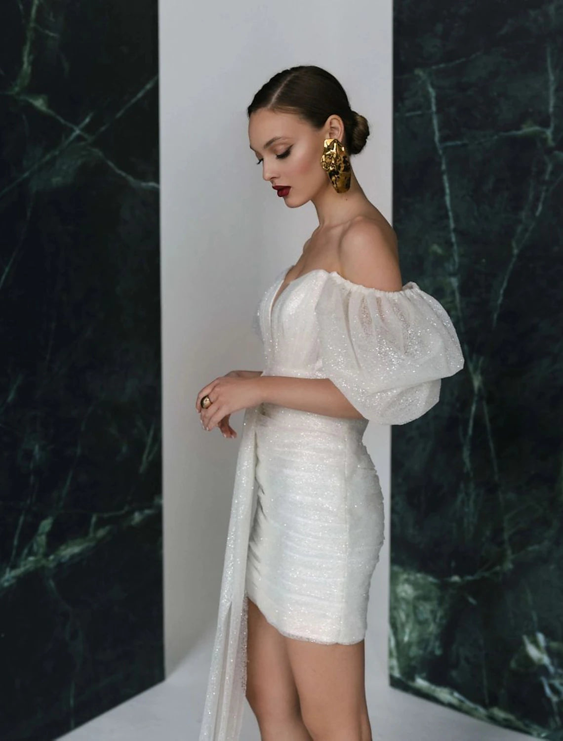 Side profile of the V-neck short sleeve sequined white dress.