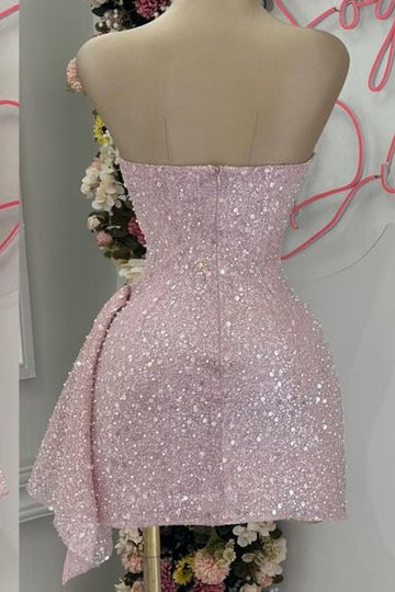 Side view of a woman wearing a blushing pink sequin mini dress.