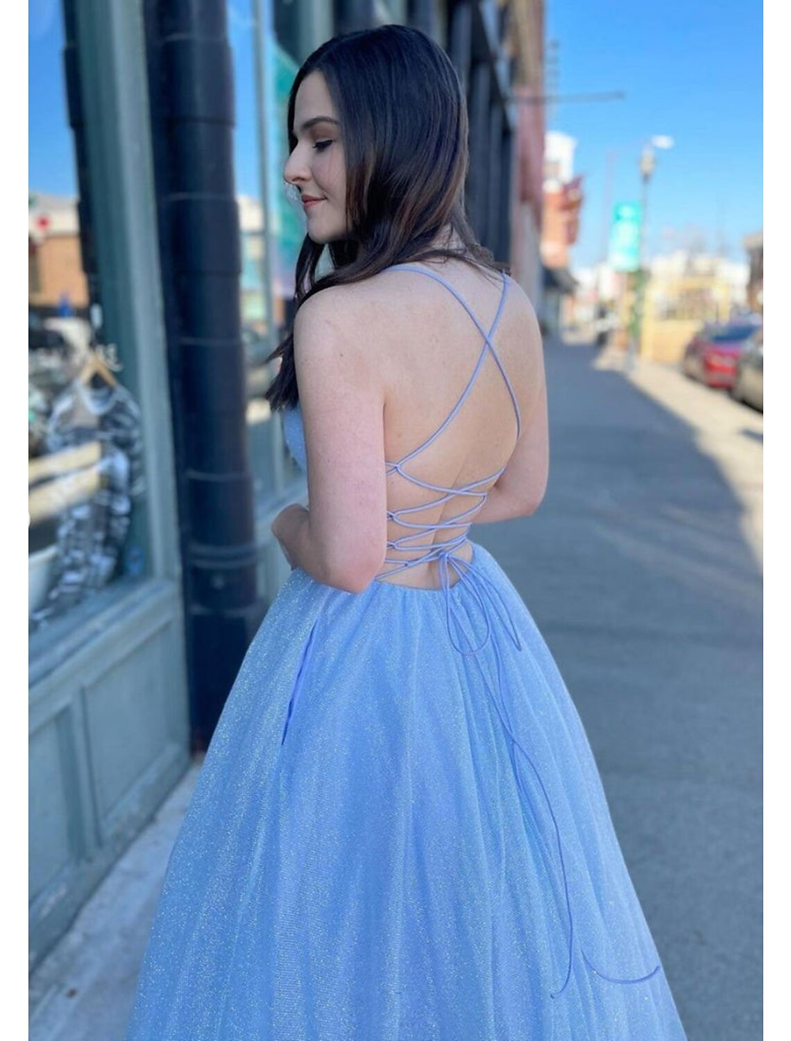 Close-up of sparkling tulle fabric and V-neckline on formal ball gown.