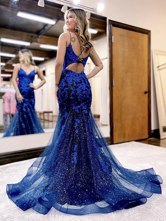 Backless trumpet prom dress with tulle fabric and beading details.