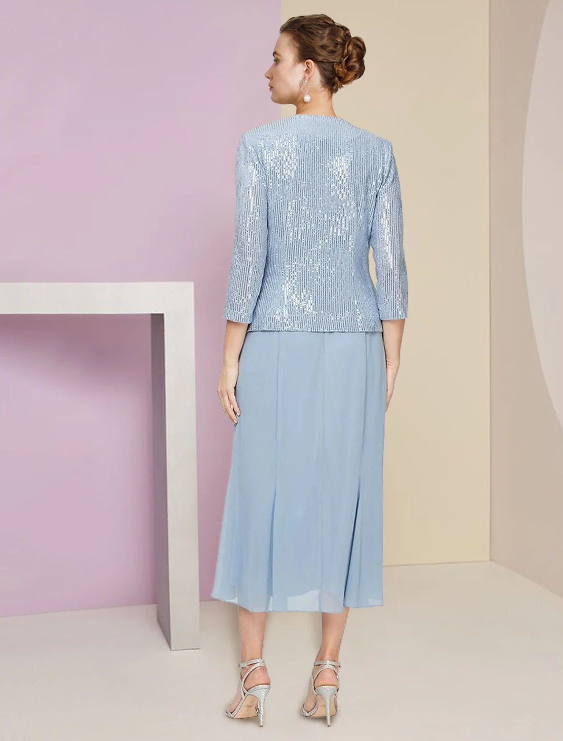 Side view of the sparkling dark blue tea-length dress and matching jacket.