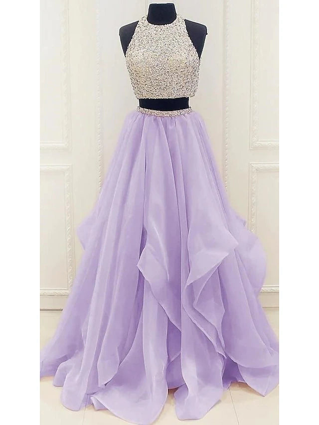 Back view of a two-piece halter ball gown prom dress, showcasing the elegant silhouette and sequin embellishments.