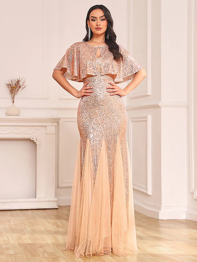 Model in sparkling two-piece mermaid dress with sequin shawl, front view.