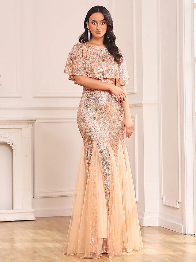 Model in sparkling two-piece mermaid dress, back view showing V-back.