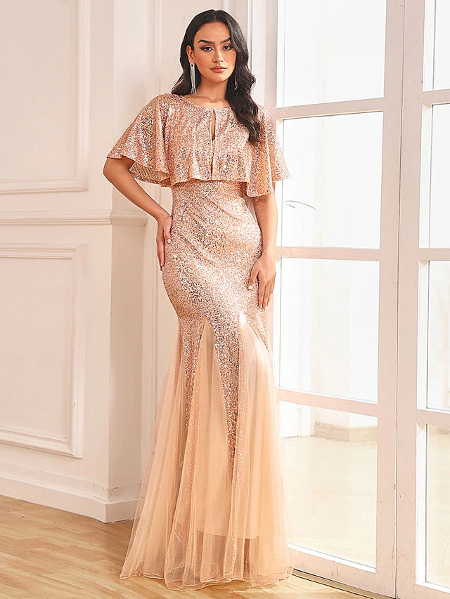 Model in sparkling two-piece mermaid dress, close-up of bodice and V-neck.