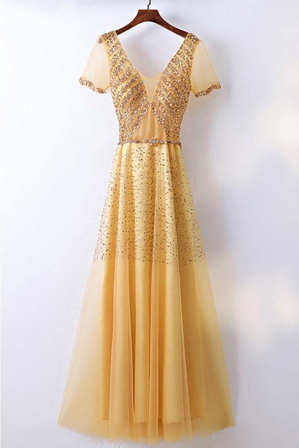 Woman wearing a sparkly A-line formal prom gown.